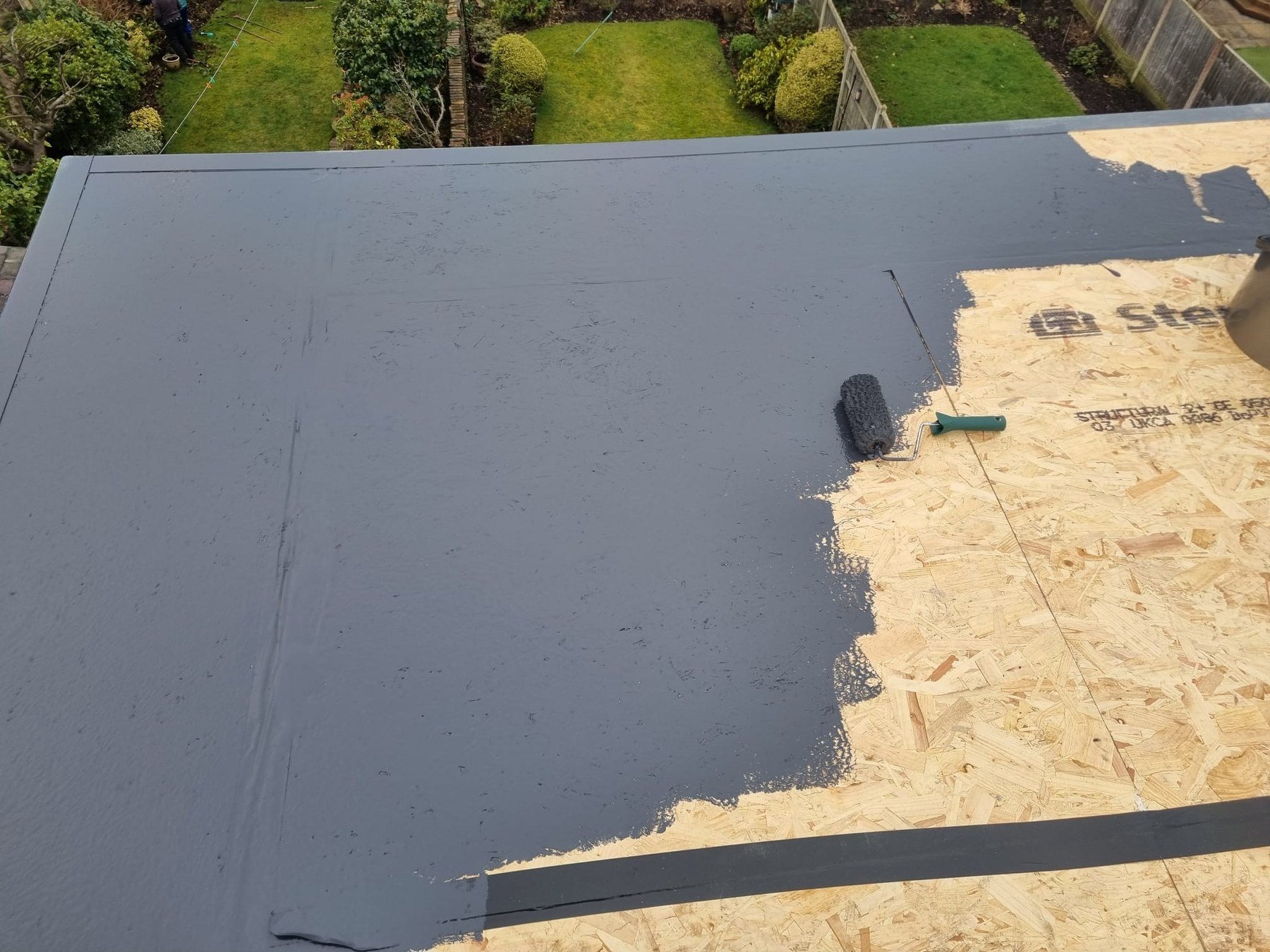Flat roof coating in progress